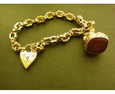 A fancy-link bracelet - Suspending a carnelian fob seal with the initial 'D' - Padlock stamped 9ct - Length 22.5cms - Weight 