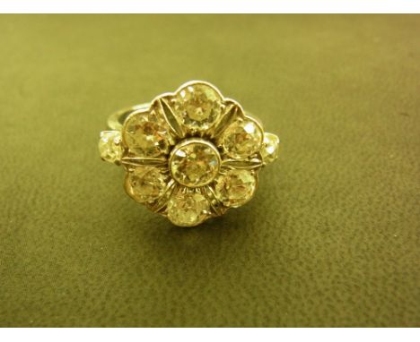 A mid 20th century 18ct gold diamond floral cluster ring - The old-cut diamonds to the plain band - Estimated total diamond w