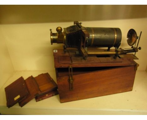 A mahogany and brass R R Beard - ECLIPSE - projector reg. no 519324 with four mahogany photographic slides - not for the proj