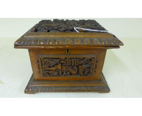 A Chinese boxwood casket with deep relief carved panels depicting buildings, trees and figures - Height 13 cm x 18 cm x 14 cm
