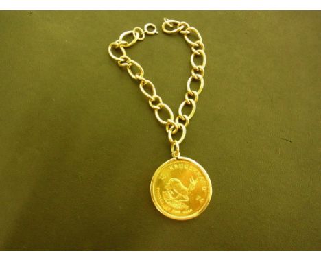 A 1974 Krugerrand coin - Suspended from a 9ct gold curb-link bracelet - Hallmarked Birmingham - Length 20cms - Weight approx 