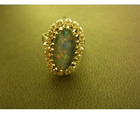 An opal triplet and diamond cluster ring - Stamped K18 - Ring size N - Weight approx 6.6gms 
Condition Report: Good