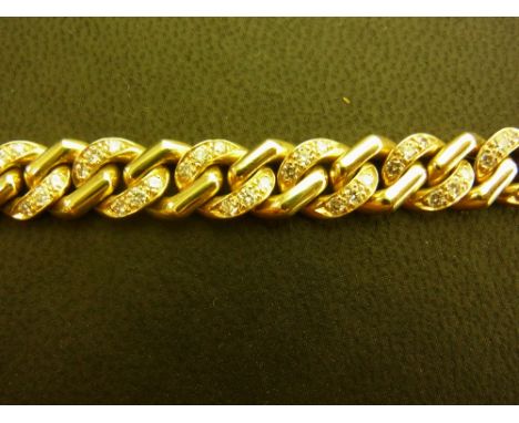 A diamond curb-link bracelet - The alternating links set with brilliant-cut diamonds Stamped 750 Length 19.5cms - Weight appr