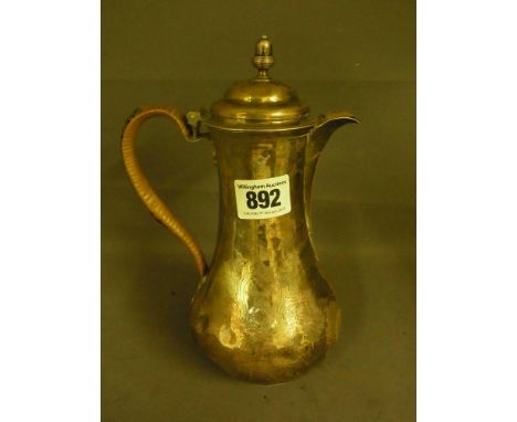 A George II silver hot water jug - Hallmarked London 1752 by Thomas Whipham - bound cane handle - hinged lid with acorn finia