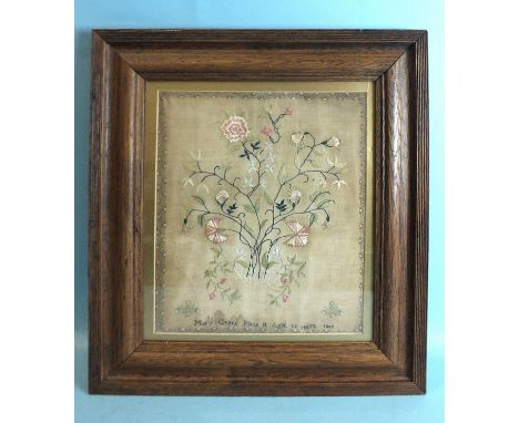 A Victorian needlework silk sampler, depicting a vase of flowers within a flower head and leaf border, by Mary Crane Face It 