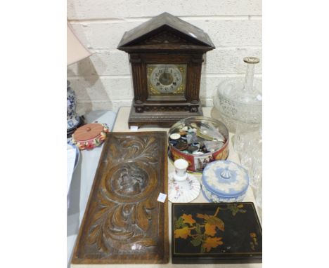 A stained and carved wood striking mantel clock of architectural form (af), 39cm high, an oak rectangular panel decorated wit