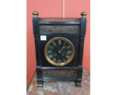 A 19th Century French Belge noir and parcel gilt mantel clock