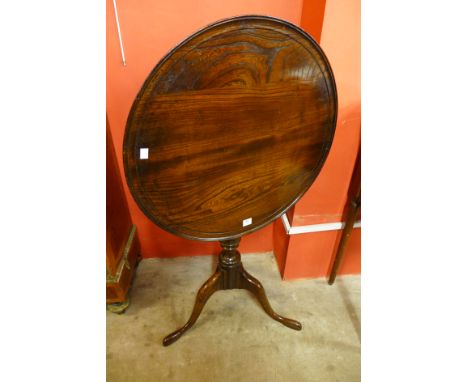 A George III style oak circular tilt-top birdcage action tripod table