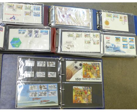 A collection of stamps and Channel Islands First Day Covers in seven albums