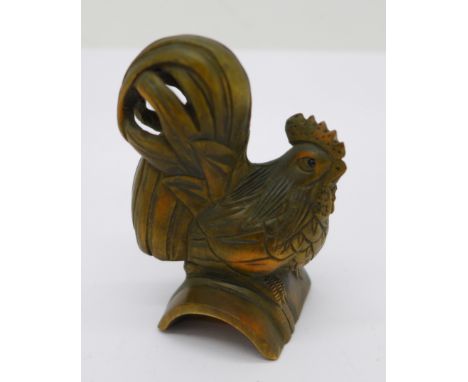 A carved wooden netsuke in the form of a cockerel, signed