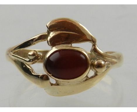 A 9 carat yellow gold and orange stone ring, possibly Mexican fire opal, in the Art Nouveau taste. 