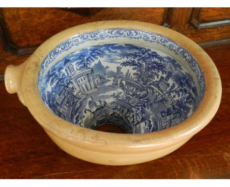 A Victorian Staffordshire blue and white ceramic toilet bowl, decorated with landscape scenes. 