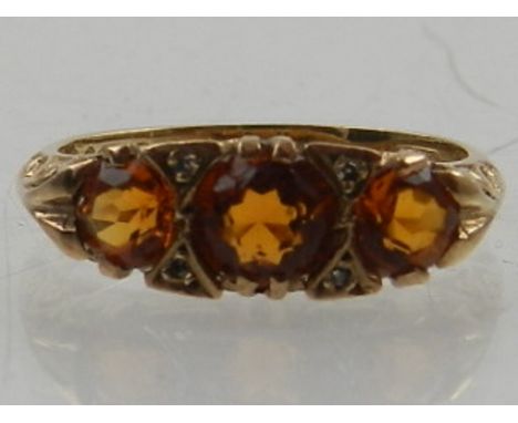 A 9 carat yellow gold, diamond, and Mexican fire opal ring, set three round cut opals. 