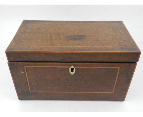 An Edwardian mahogany tea caddy, boxwood line inlaid, with ivory escutcheon (lacking key), opening to reveal double lidded co