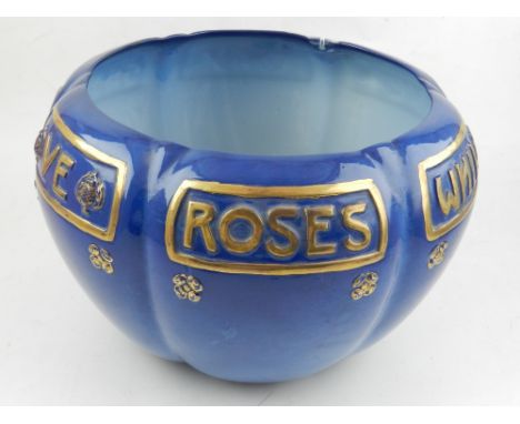 A Royal Worcester Sabrina porcelain flower pot, decorated in gilt with rosettes text on a blue ground, bears factory mark to 