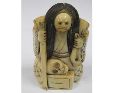 HEAVILY CARVED IVORY NETSUKE WITH ROTATING FACE, SIGNED TO BASE 