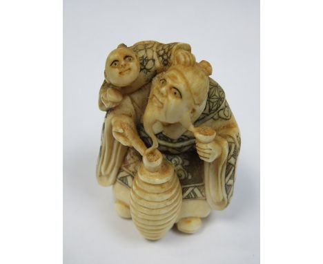 HEAVILY CARVED IVORY NETSUKE, SIGNED TO BASE 