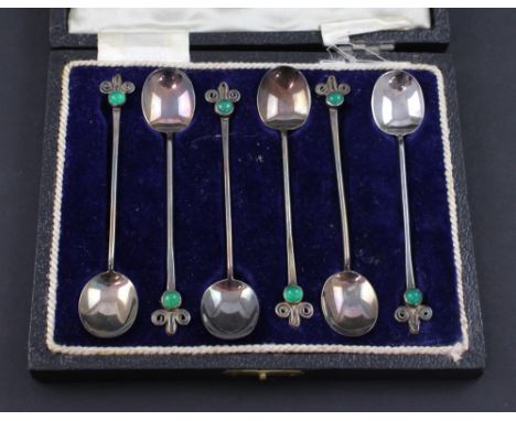 A cased George V hallmarked silver set of six coffee spoons with Art Deco finial set with jade-coloured cabochon stones, Char