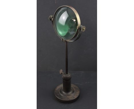 A Vintage cast and wrought iron magnifying glass on stand, base marked 'CD &amp; Co London', height 41cm.