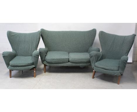 A good 1950s Modernist three-piece suite with splayed arms and flared back, comprising two chairs and a two-seater sofa, widt