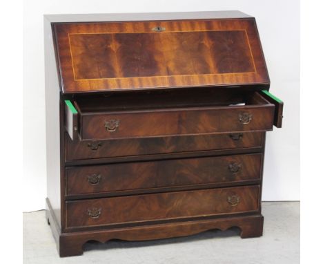 A reproduction mahogany inlaid bureau, drop-down desktop with interior pigeonholes and drawers over four drawers to bracket s
