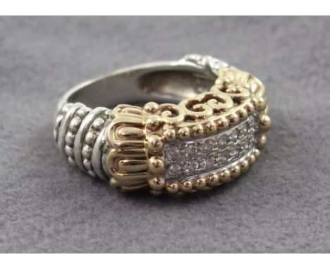 A 14ct white and yellow gold dress ring set with small white stones, size K, approx 10g.