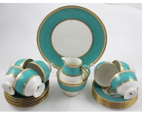 A Wedgwood mottled turquoise and gilt eight-setting part tea service comprising seven cups, seven saucers, six side plates, s