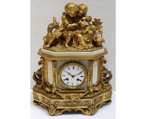 A late 19th/early 20th century French Harvey & Cie ornate gilded eight-day mantel clock, children in period dress picnicking 