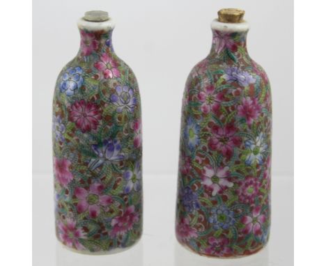 A pair of small Canton enamel-decorated Chinese porcelain scent bottles with red seal marks to the base of each and cork stop