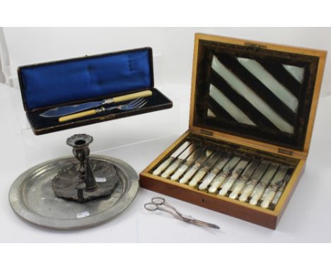 A cased set of abalone-handled flatware, a Tudric pewter charger, an Old Sheffield Plate chamber stick, a set of grape scisso