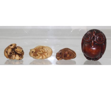 Four netsuke to include three vegetable ivory examples, a crocodile, a rat emerging from a bag of grain, two toads on a fruit