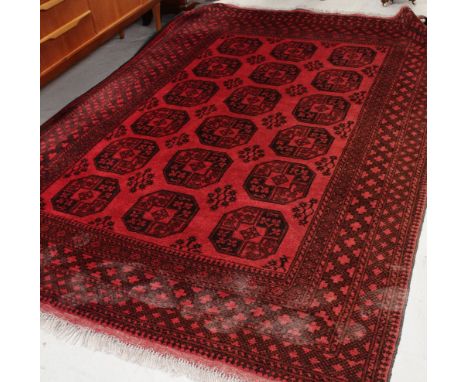 A large red ground Bokhara carpet with geometric multi-border, width 202cm.