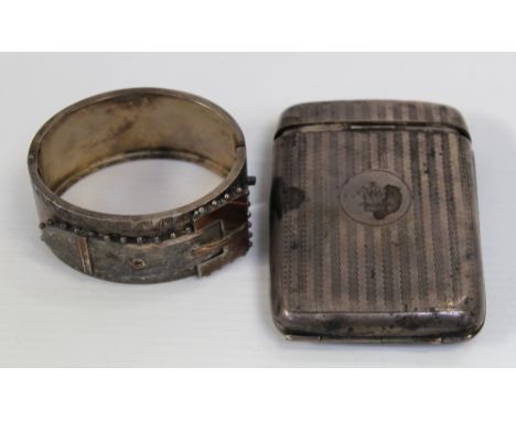 A hallmarked silver cigarette case and a hallmarked silver bangle (2).