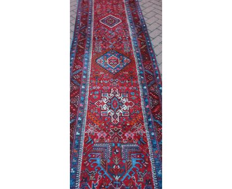 A Persian hand-made Heriz runner, 455 x 92cm.