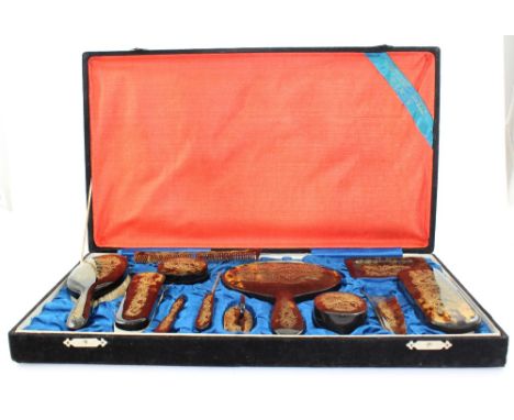 An early 20th century cased twelve-piece tortoiseshell dressing table set comprising various brushes, mirror, comb, manicure 