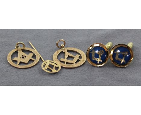 Two 9ct gold Masonic pendants, a 9ct gold matching stick pin and a pair of Masonic yellow and blue metal Masonic cufflinks, c