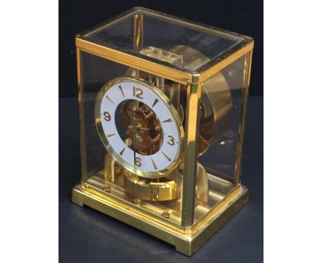 A Jaeger-leCoultre 467732 skeleton mantel clock, circular white enamel and gilded dial set with Arabic and baton numerals in 