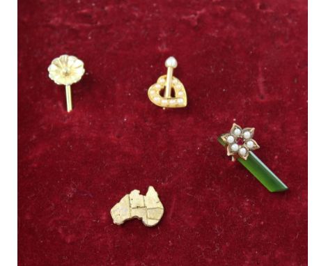 Four yellow metal stick pins to include a floral example, a heart set with tiny seed pearls, a map of Australia and a floral-