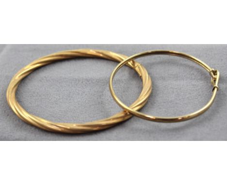 A 9ct gold twist bangle and a yellow metal bangle with a small white sapphire clasp, approx combined 9.5g (2).