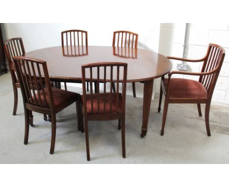 Waring &amp; Gillows; an Edwardian mahogany wind-out table with single and half-leaf, on boxwood inlaid base with square tape