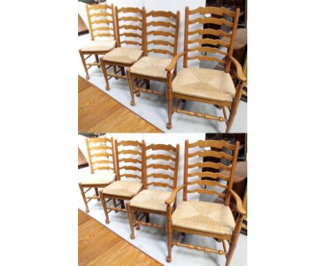 A set of eight country-style modern beech ladder-back dining chairs with rush seats (6 + 2), height of carvers 106cm (8).