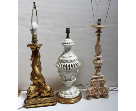 Three decorative table lamps to include a white ceramic baluster lamp with pierced decoration and leaf and flora applied deco
