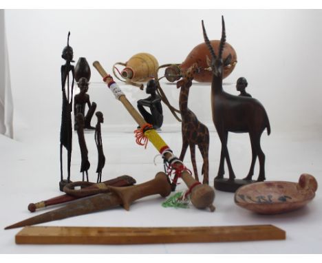 A collection of African and Middle Eastern items to include two Maasai gourd bottles with shell decoration, several carved Af