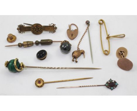 A group of yellow metal and gold stick pins, one set with a red stone and turquoise, one with a kiwi charm etc and a small qu