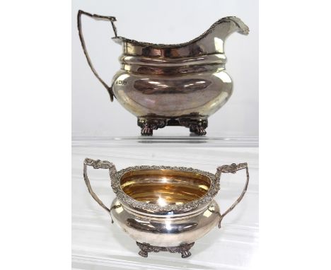 An Edward VII hallmarked silver sucrier and milk jug with bear mask terminals, Chester 1906, approx combined 17ozt (2).