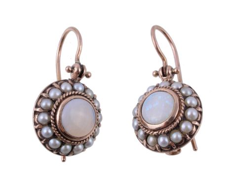  A pair of opal and pearl earrings,   the central circular cabochon opal collet set within a surround of pearls, with shepher