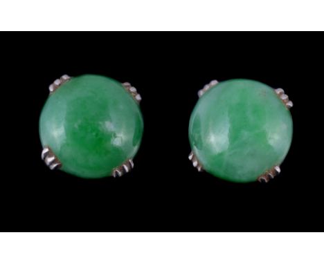  A pair of jadeite jade ear studs,   the circular cabochon jadeite jade in four claw settings, with post fittings, 1cm diamet