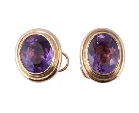  A pair of amethyst earrings,   the oval cut amethysts in collet settings, with post fittings, stamped 18K, 1.8cm long 
