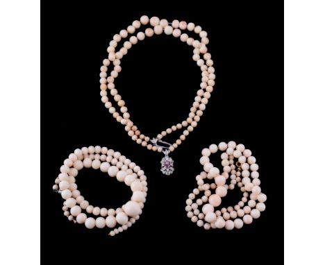  A coral necklace,   the two strands of graduating coral beads with a ruby and diamond set clasp, stamped 750 with Italian co