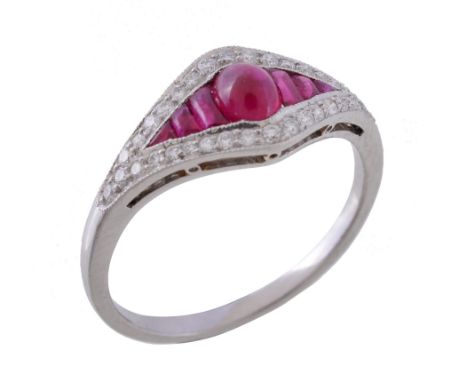  A ruby and diamond ring,   the central oval cabochon ruby between calibre cut rubies, within a surround of brilliant cut dia